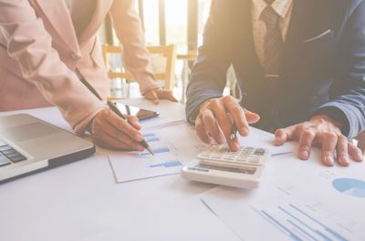 How UK Universities Are Financing Campus Expansion in 2026 People at documents